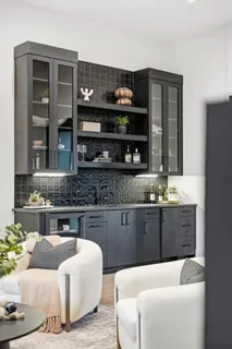 a kitchen with a wooden floor and cabinets