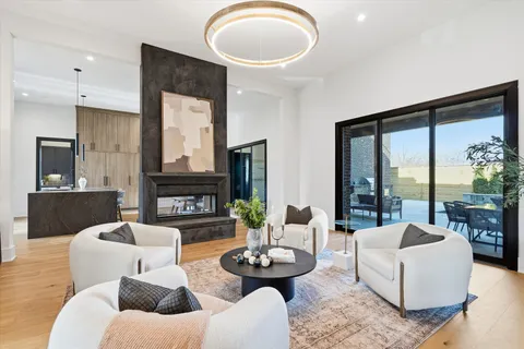 a view of a hallway with wooden floor and a living room