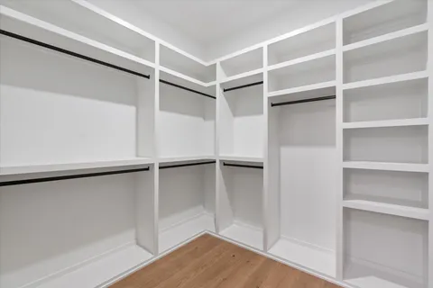 a view of a hallway with a livingroom and a bathroom