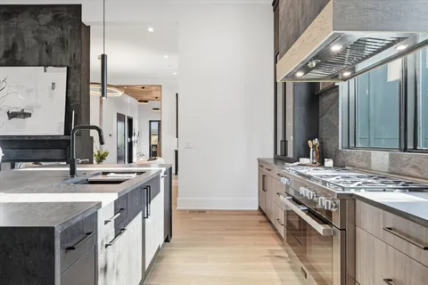a bathroom with a granite countertop sink a toilet and a mirror