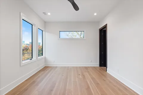 a spacious bedroom with a bed a couch and a window with outer view