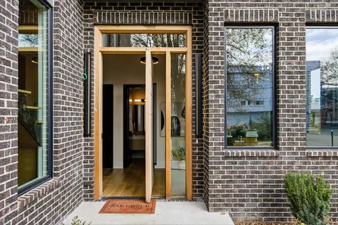 a living room with furniture and floor to ceiling windows