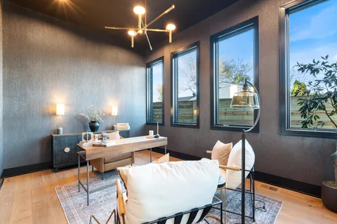 a living room with furniture a fireplace and a large window