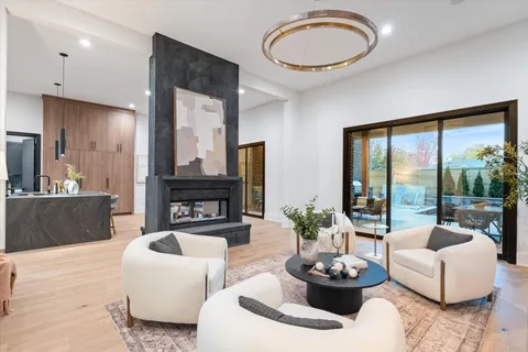 a kitchen with stainless steel appliances kitchen island granite countertop a table chairs sink and cabinets