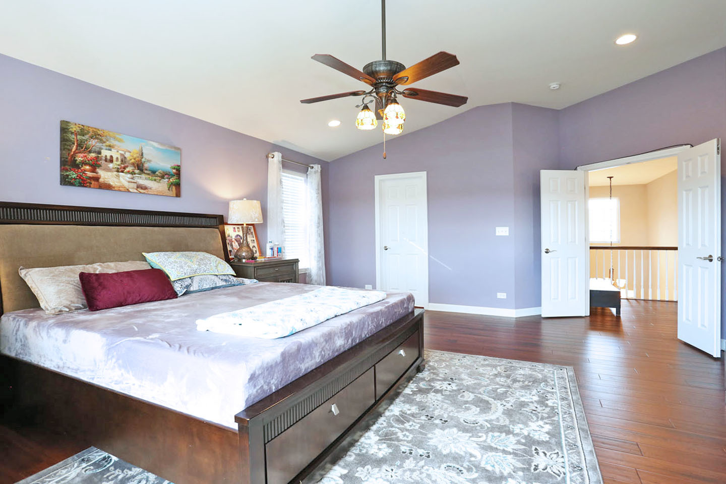 3441 Harold Circle Hoffman Estates, IL 60192 - Photo 23 of 34 a spacious bedroom with a bed and a chandelier