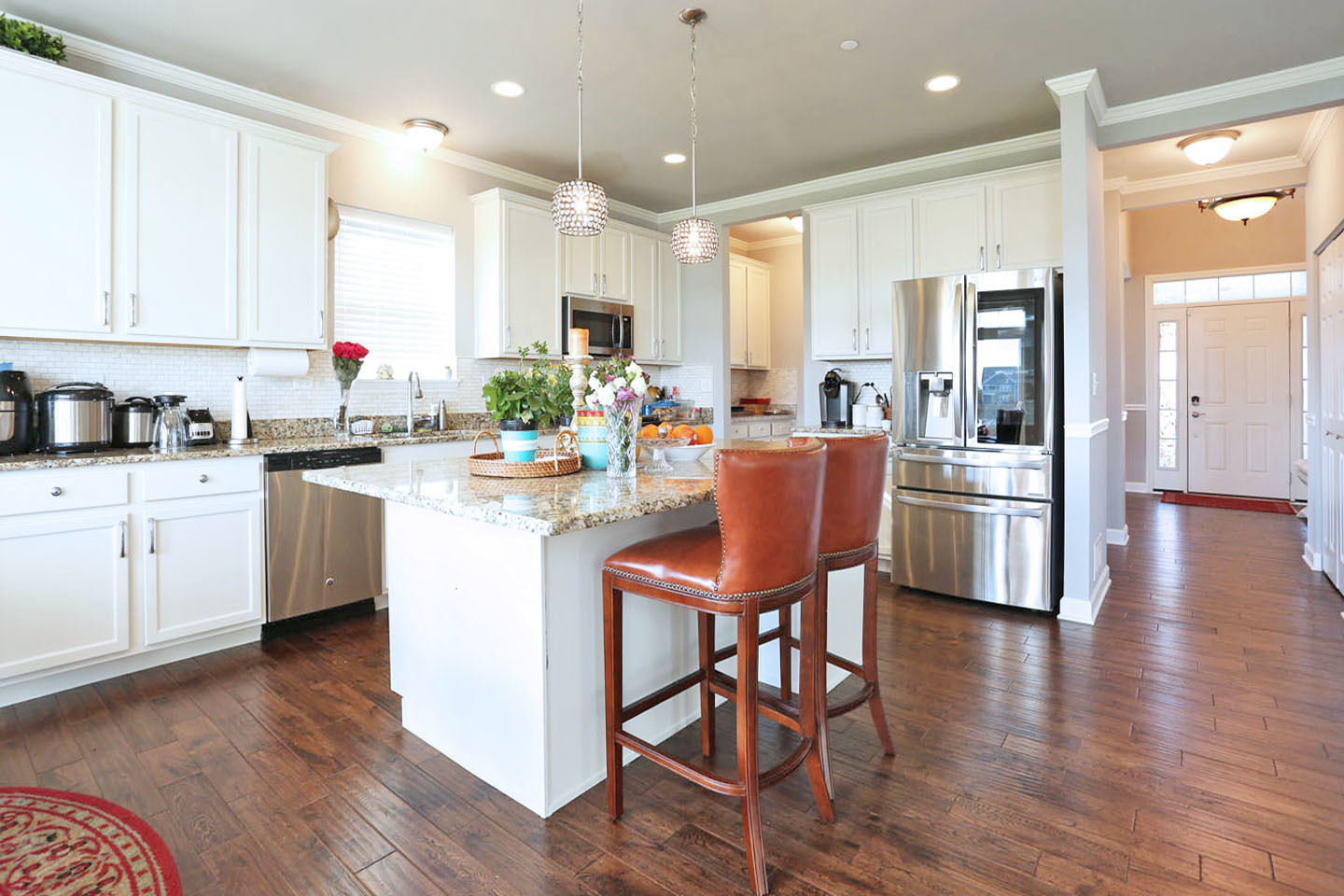 3441 Harold Circle Hoffman Estates, IL 60192 - Photo 7 of 34 a kitchen with stainless steel appliances kitchen island granite countertop wooden floors and white cabinets