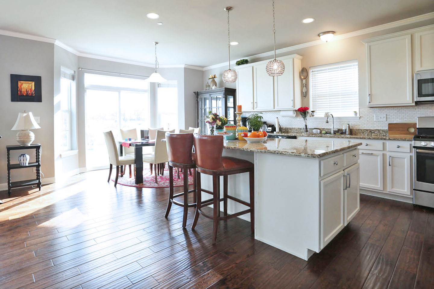 3441 Harold Circle Hoffman Estates, IL 60192 - Photo 8 of 34 a kitchen with a table chairs stove and wooden floor