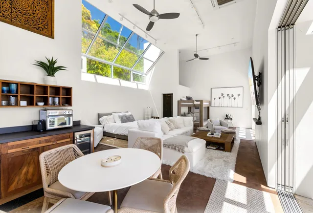 a living room with furniture a rug and a chandelier