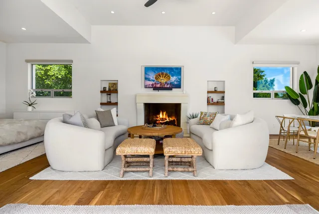 a living room with furniture and a fireplace