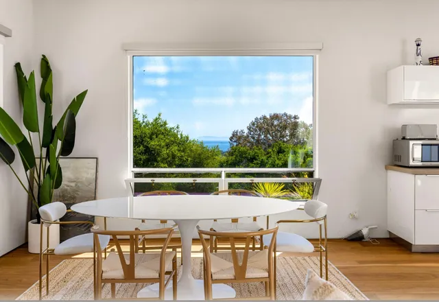 a view of a dining room with furniture window and outside view