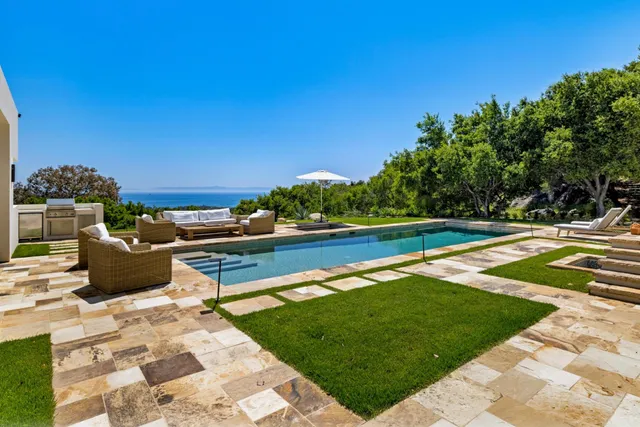 a view of a swimming pool with a lounge chair
