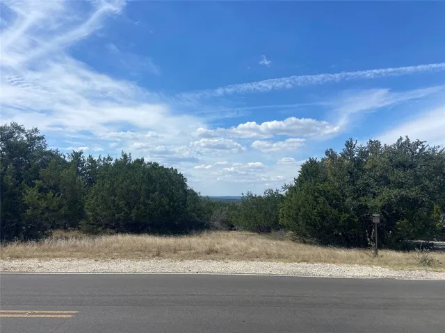 a view of a yard and car parked