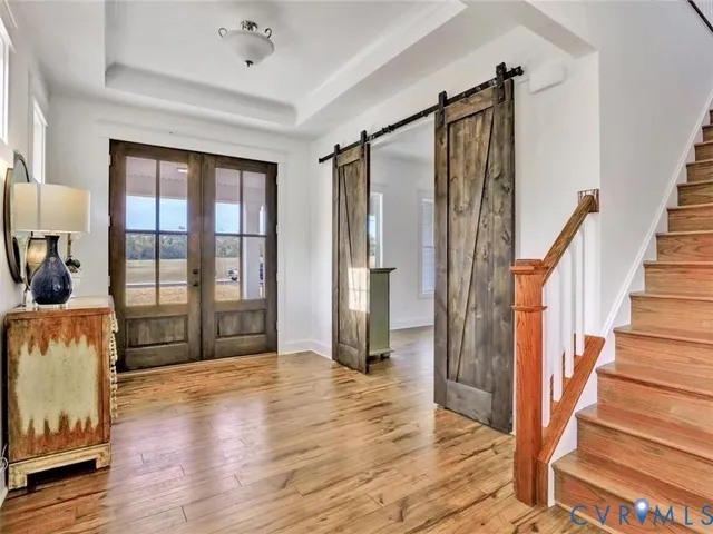 a view of entryway with wooden floor and door