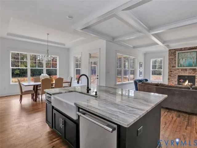 a kitchen with granite countertop a table chairs stove and kitchen view