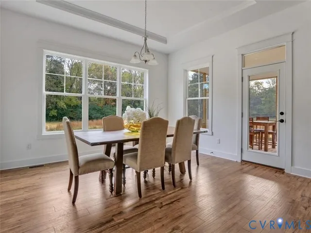 a view of a dining room with furniture window and wooden floor