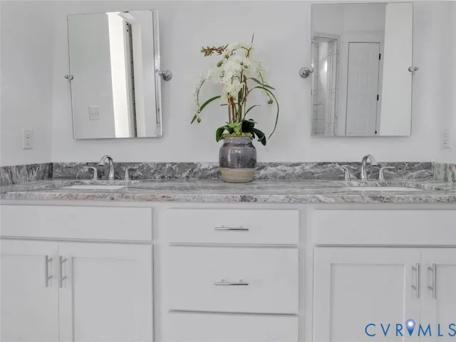 a bathroom with cabinets appliances and a sink