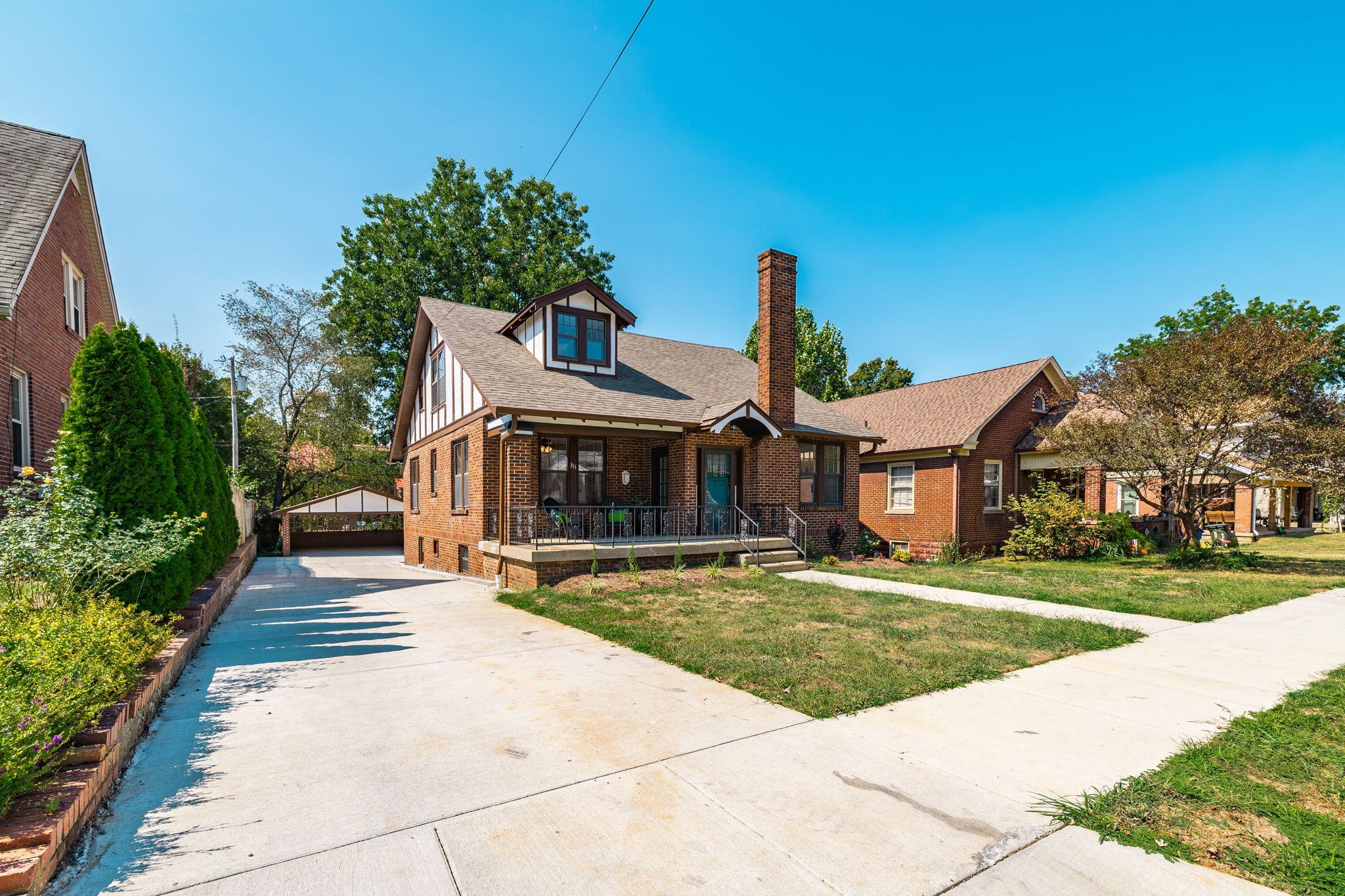 a front view of a house with a garden