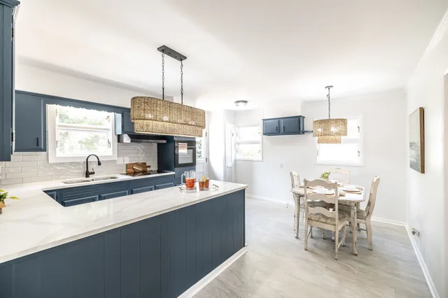 a kitchen with a sink a stove and cabinets