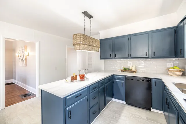 a view of a room with wooden floor and a ceiling fan