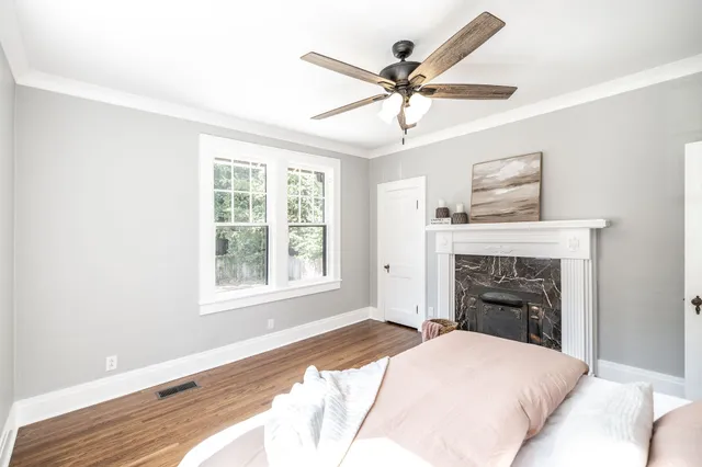 an empty room with wooden floor and windows