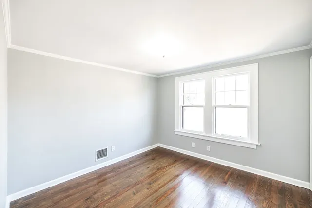 a living room with furniture a fireplace and a wooden floor