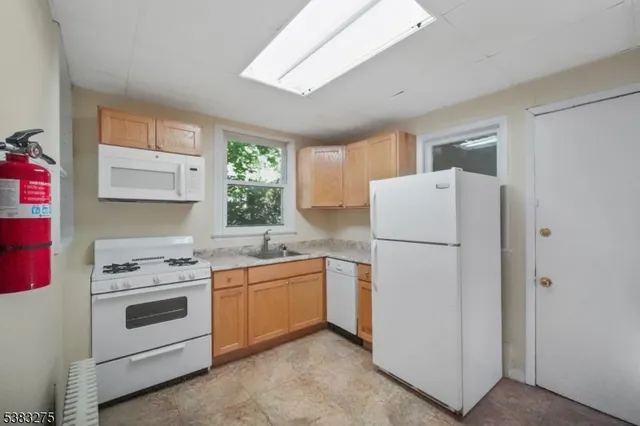 a kitchen with a white cabinets and white appliances