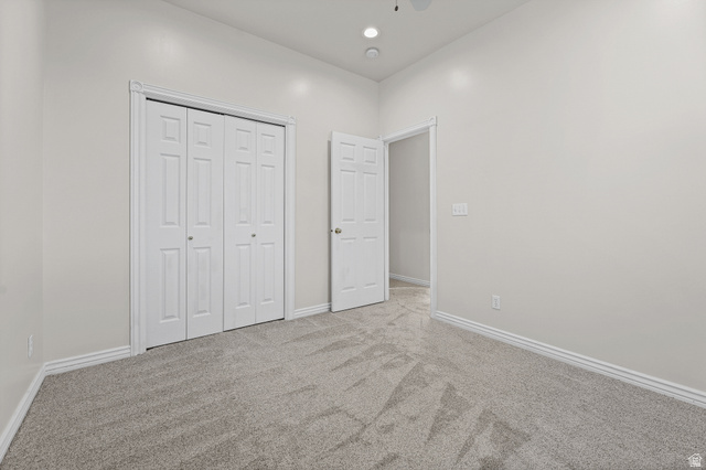 4117 North Wolf Ridge Circle Eden, UT 84310 - Photo 36 of 63 Neutral-toned room featuring a patterned grey carpet, white baseboards, and a white bi-fold closet door
