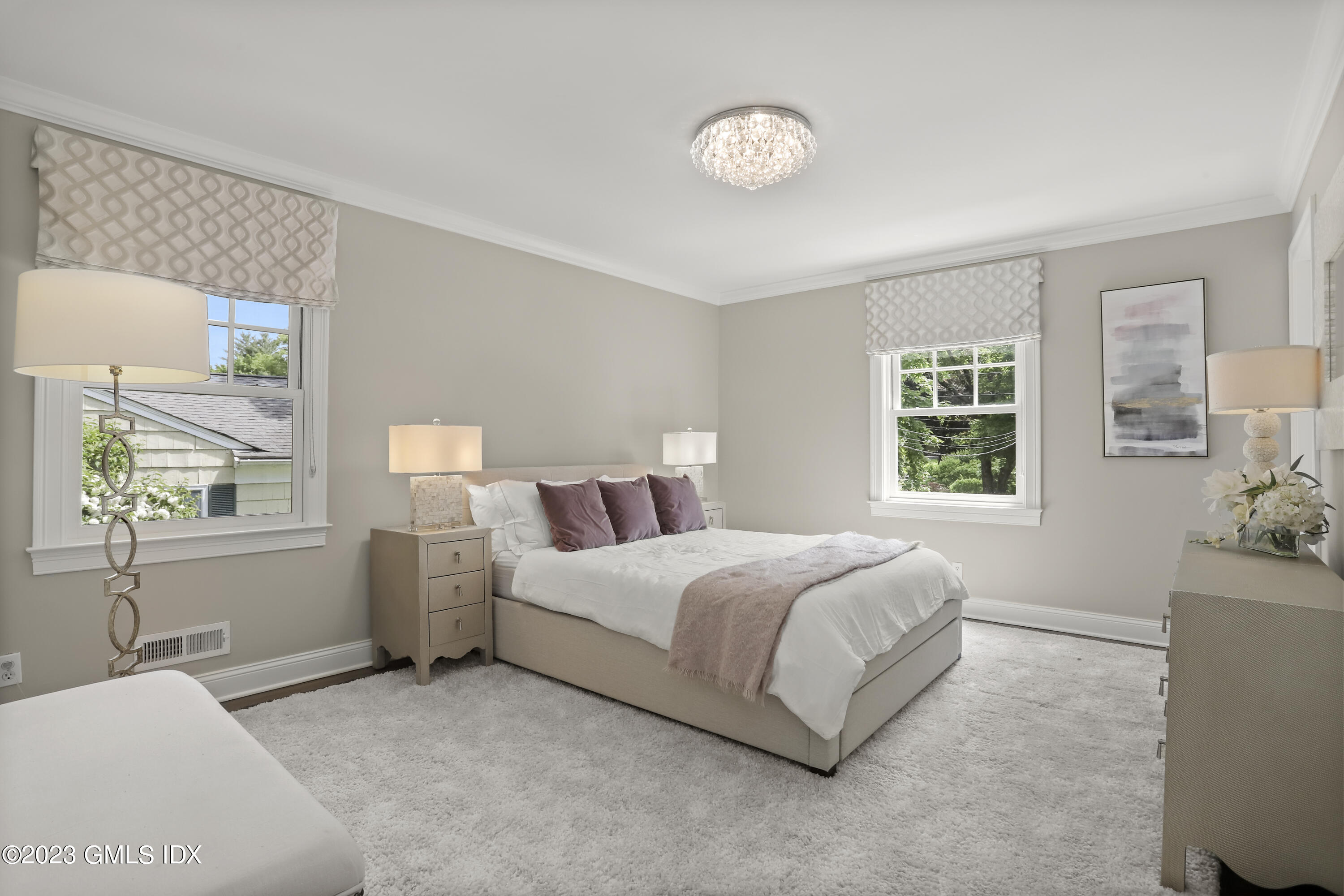 85 Mallard Drive Greenwich, CT 06830 - Photo 20 of 45 a spacious bedroom with a bed and a window