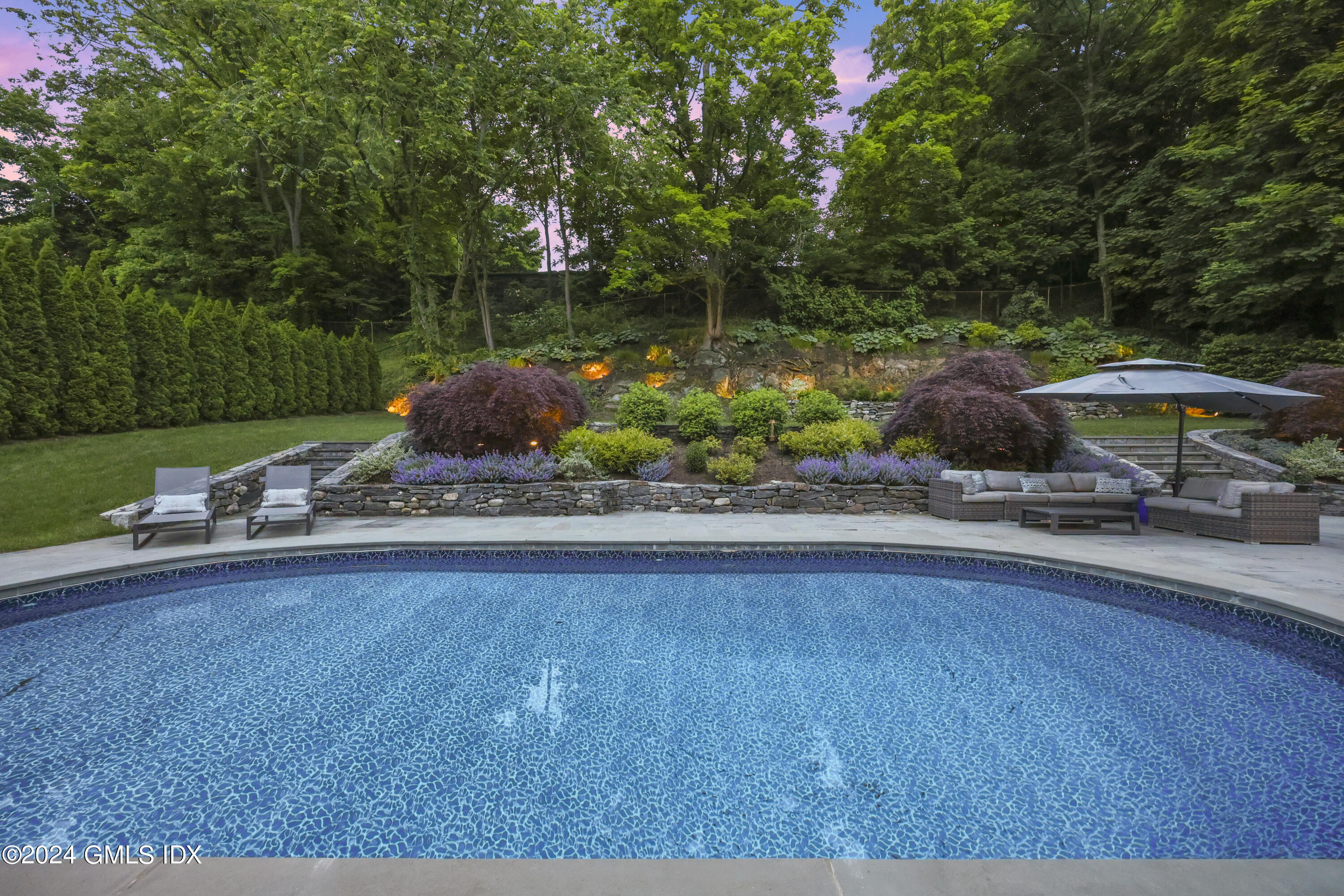 85 Mallard Drive Greenwich, CT 06830 - Photo 39 of 45 a table and chairs sitting in the garden