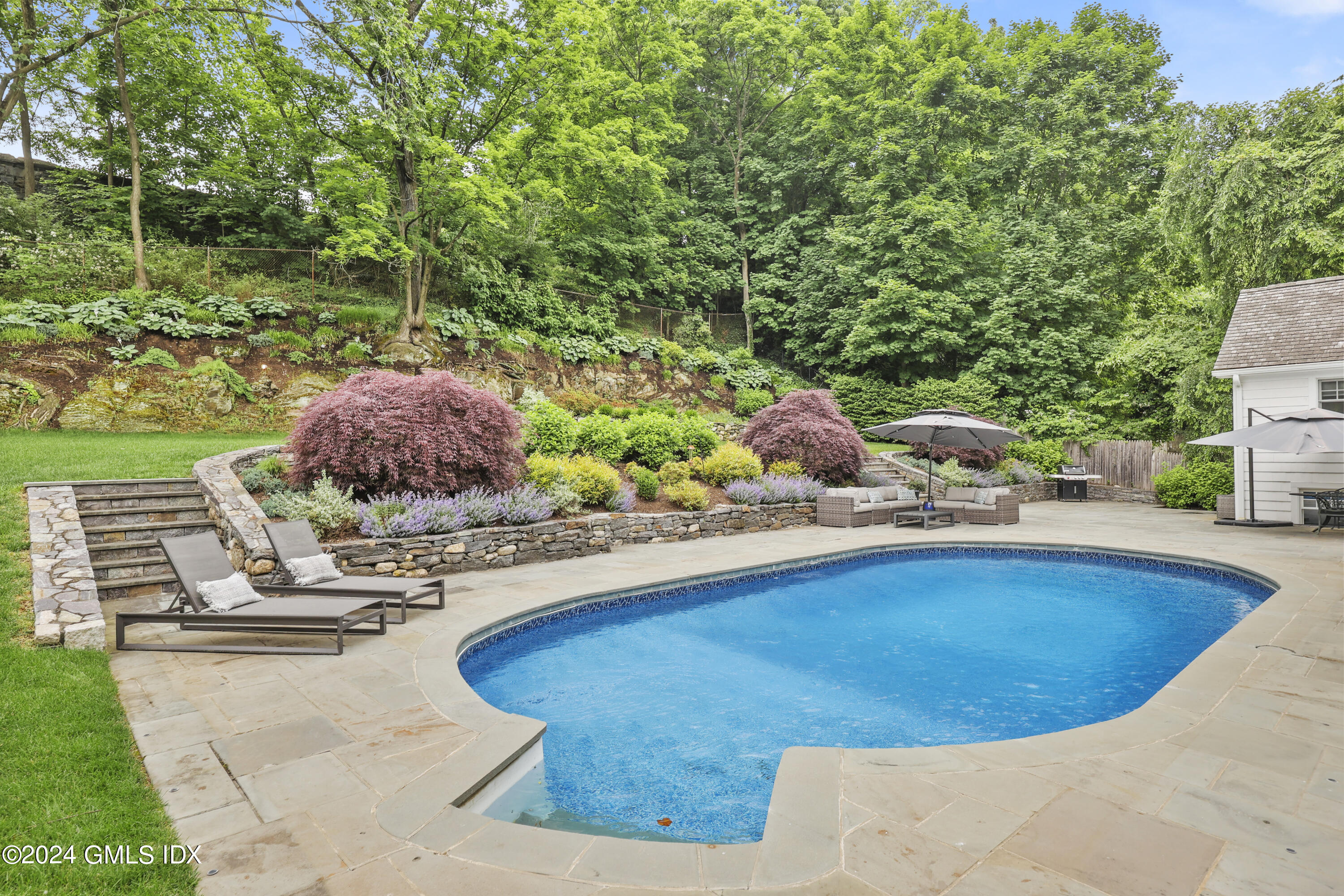 85 Mallard Drive Greenwich, CT 06830 - Photo 8 of 45 a view of a swimming pool with a patio
