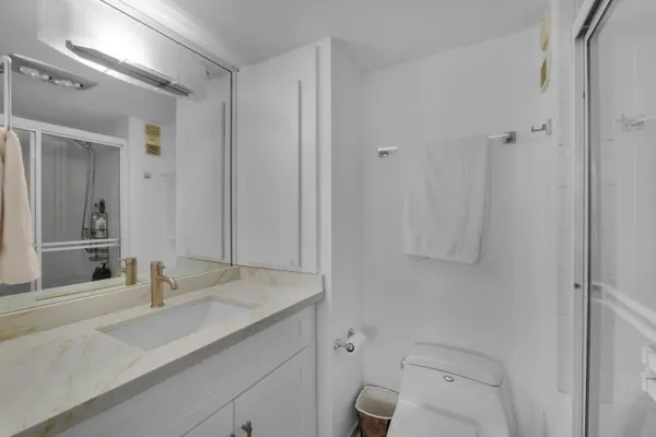 a bathroom with a sink toilet and shower