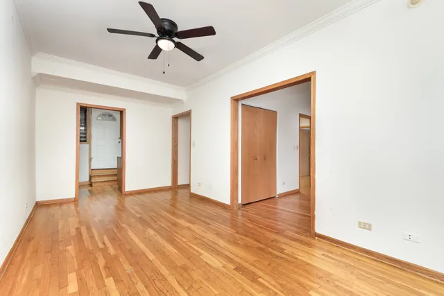 a view of an empty room and wooden floor