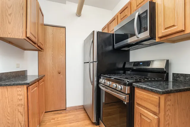 a kitchen with stainless steel appliances granite countertop a stove and a microwave