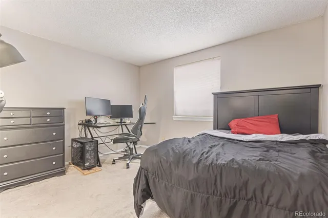 a bedroom with a bed and chair