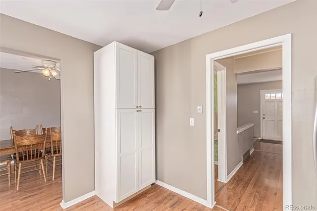 a view of a room with wooden floor furniture and windows