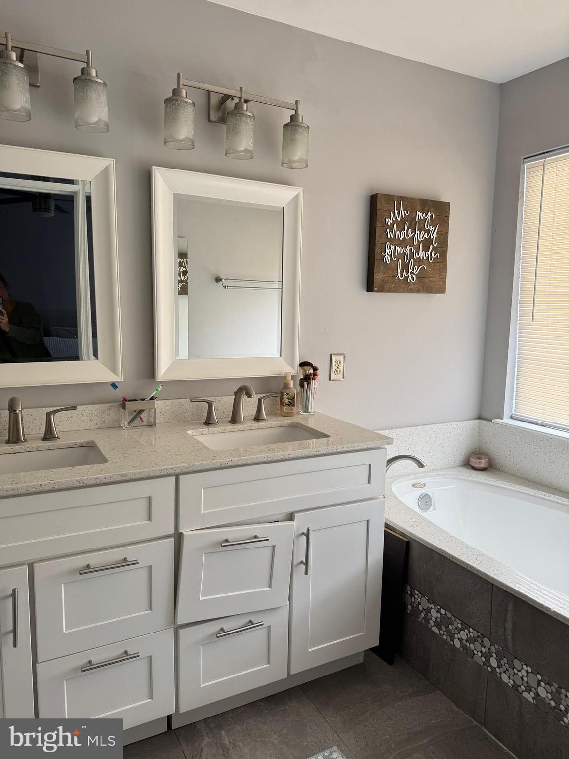 20691 Southwind Terrace Ashburn, VA 20147 - Photo 15 of 16 a bathroom with a sink and a mirror