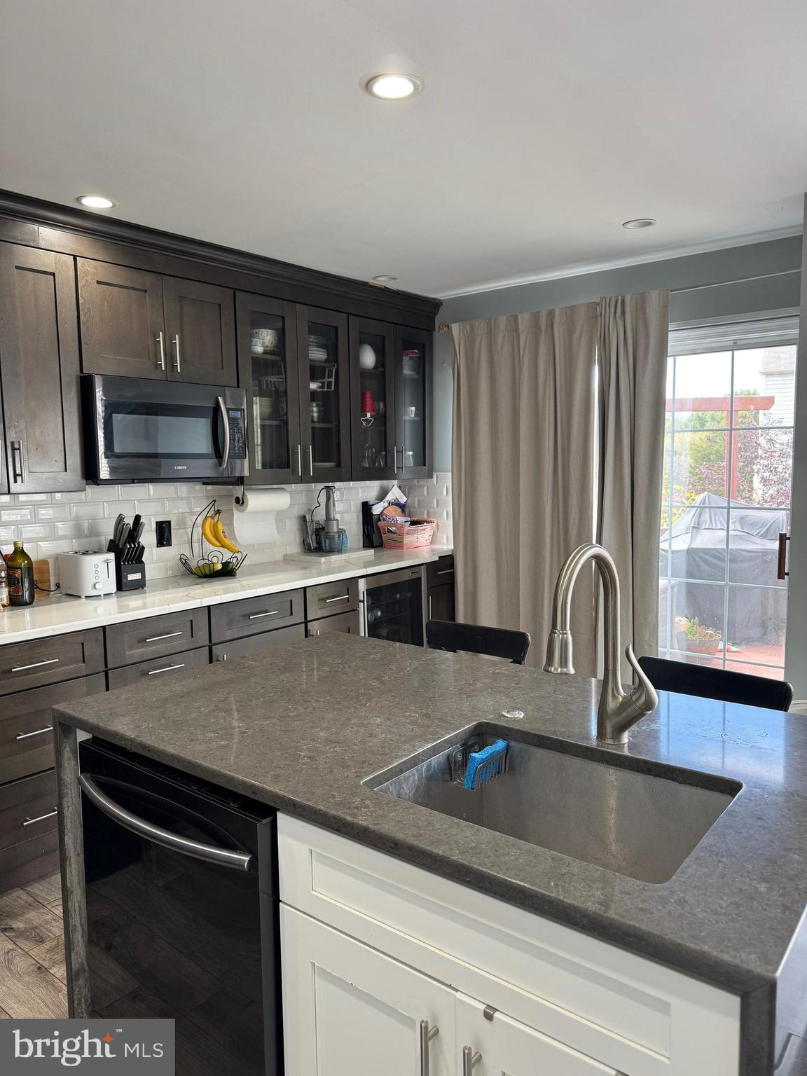 20691 Southwind Terrace Ashburn, VA 20147 - Photo 5 of 16 a kitchen with a sink and a microwave