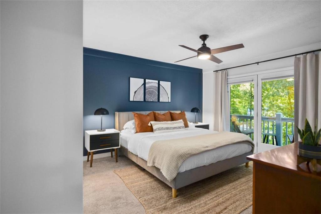 223 Mango Circle Ellijay, GA 30540 - Photo 19 of 43 a bedroom with a large bed and a chandelier