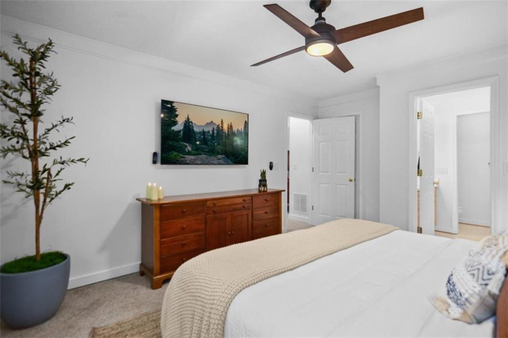 223 Mango Circle Ellijay, GA 30540 - Photo 21 of 43 a bedroom with a large bed and a flat tv screen on dresser