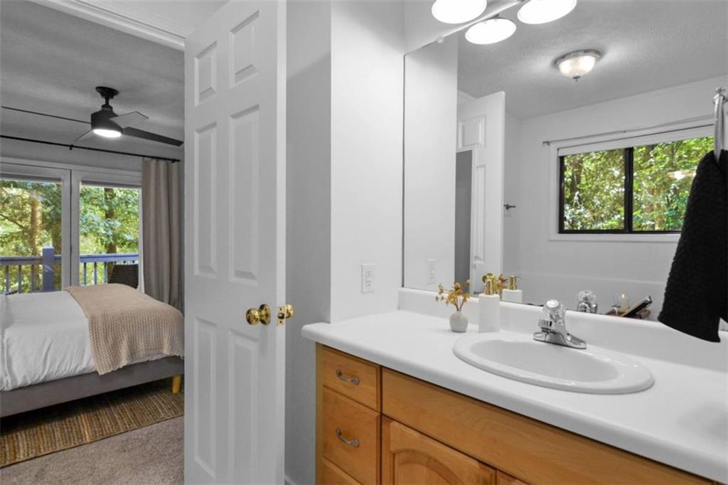 223 Mango Circle Ellijay, GA 30540 - Photo 26 of 43 a en suite bathroom with a double vanity sink a mirror and a shower