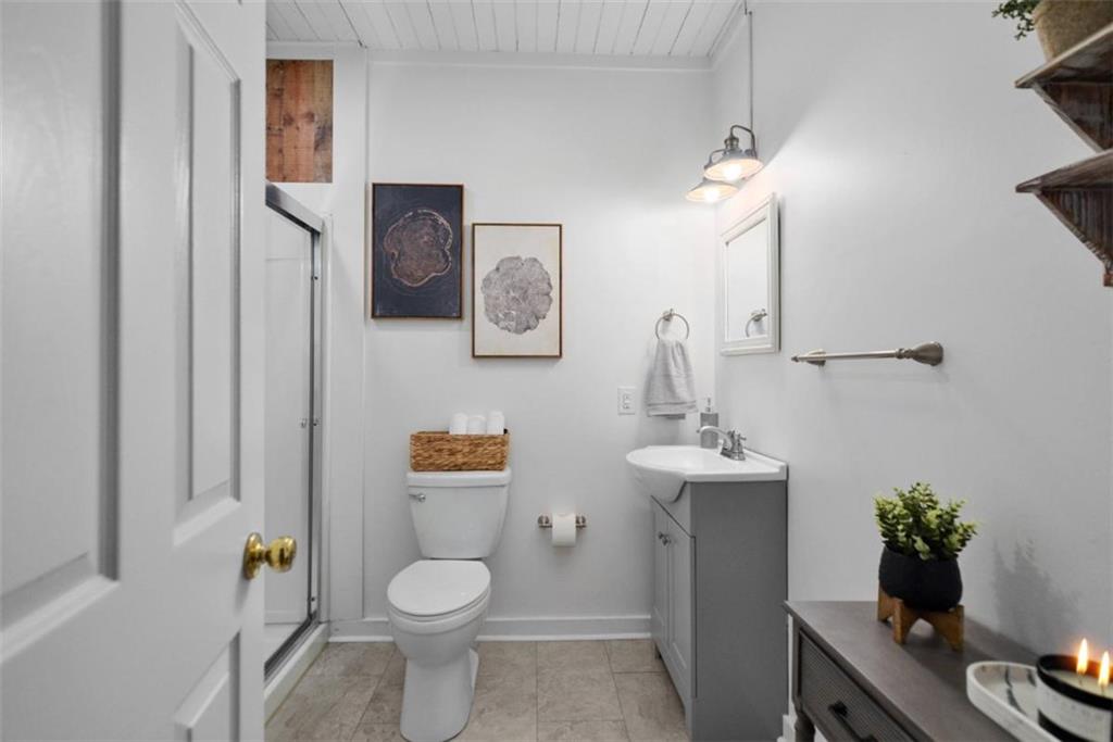 223 Mango Circle Ellijay, GA 30540 - Photo 38 of 43 a bathroom with a toilet sink and mirror