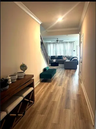 a living room with furniture and a wooden floor
