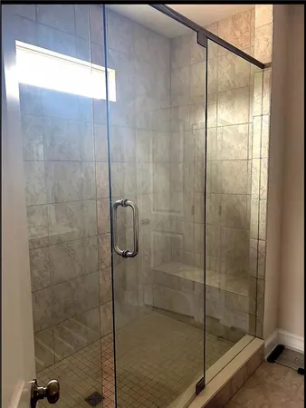 a bathroom with a glass shower door