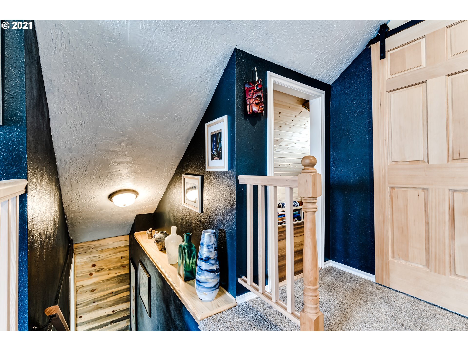 1327 E Street Springfield, OR 97477 - Photo 20 of 32 a view of a hallway with wooden floor and staircase