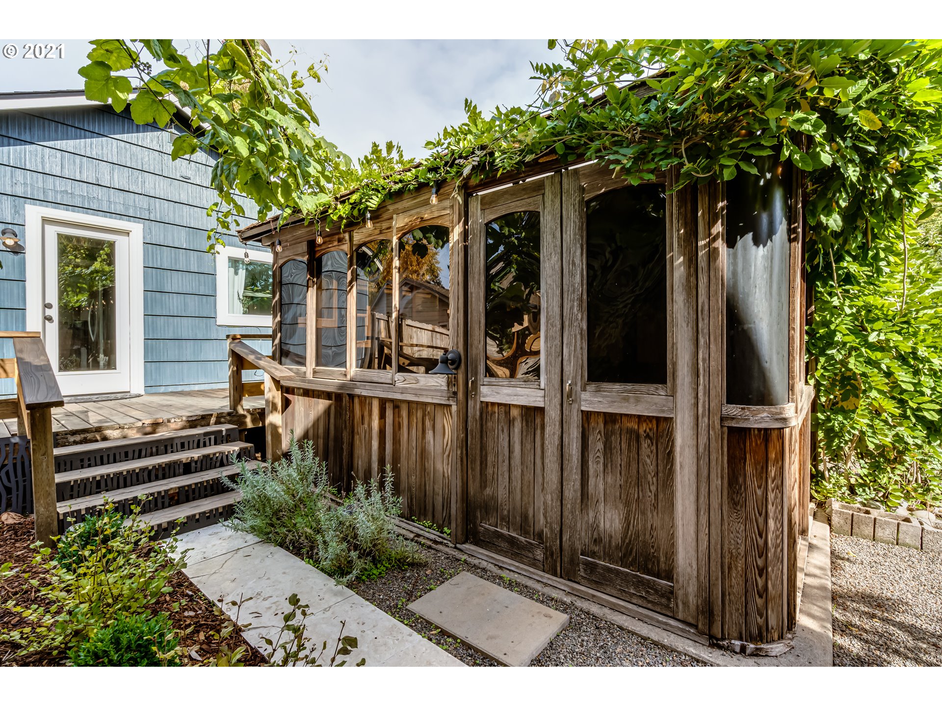 1327 E Street Springfield, OR 97477 - Photo 24 of 32 a view of backyard with potted plants and a large tree
