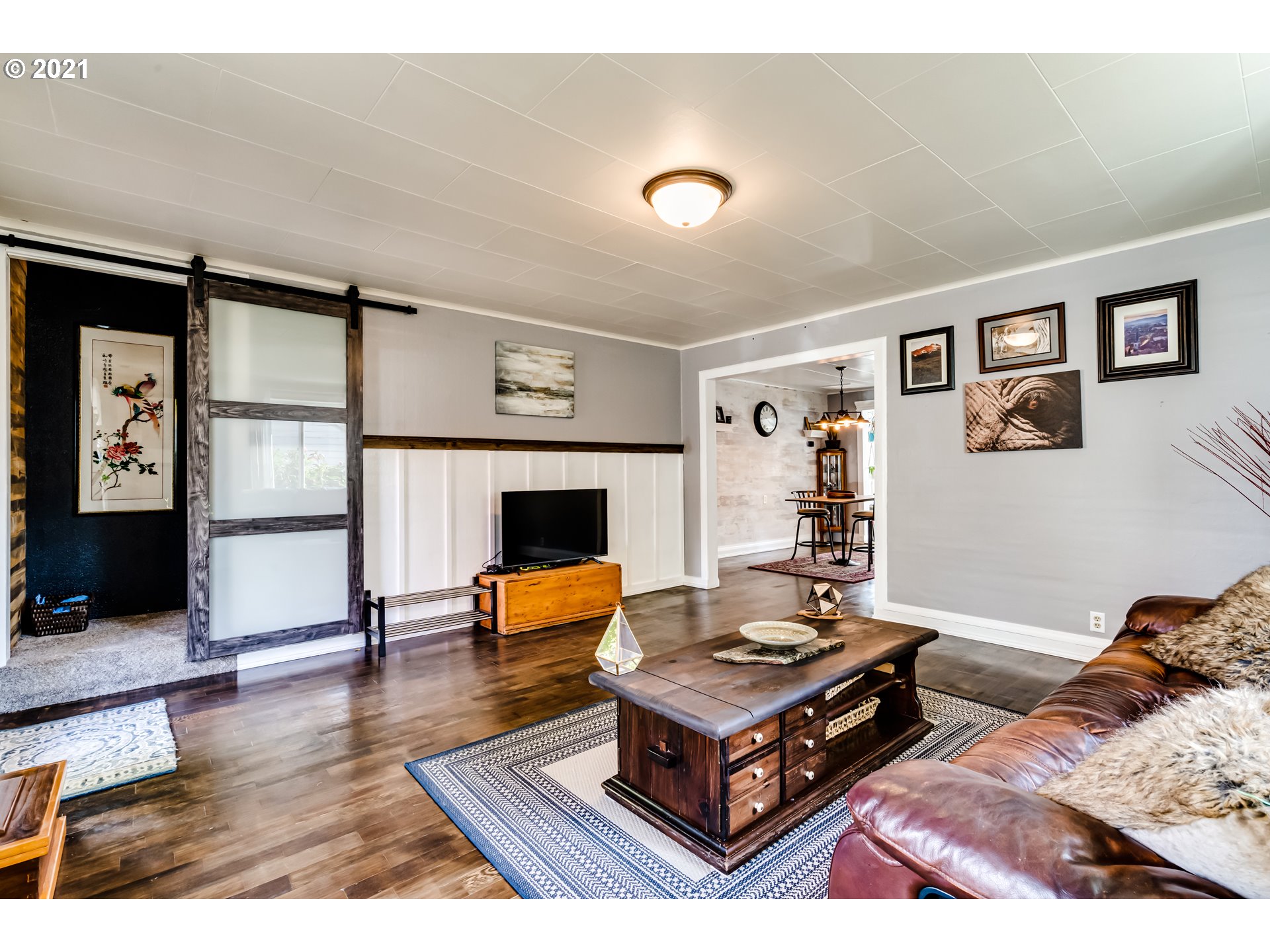 1327 E Street Springfield, OR 97477 - Photo 4 of 32 a living room with furniture and a wooden floor