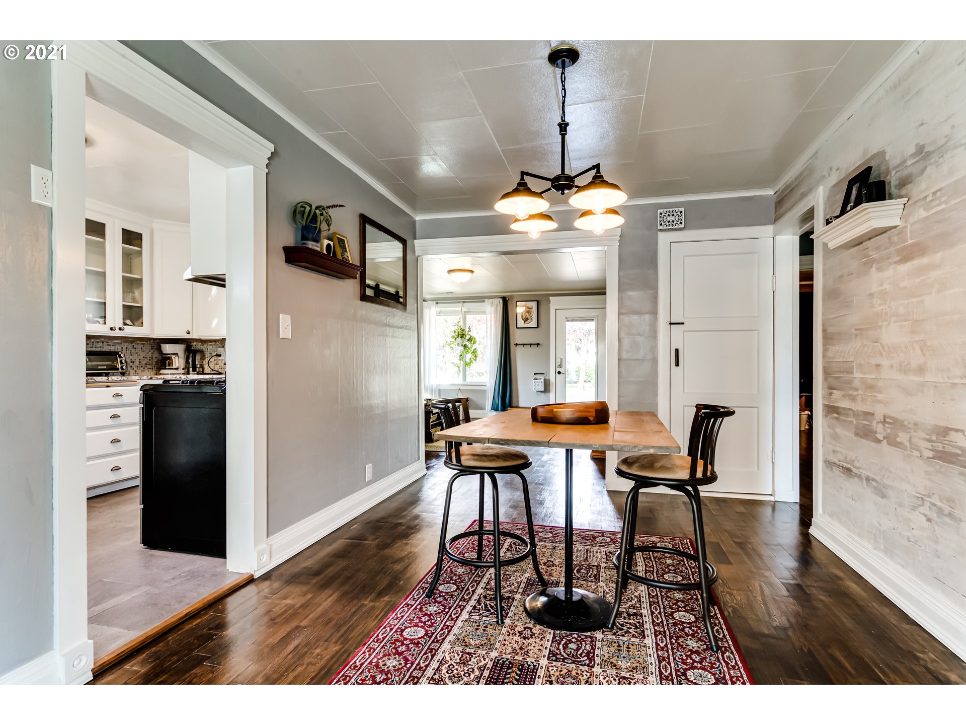 1327 E Street Springfield, OR 97477 - Photo 5 of 32 a view of a dining room with furniture wooden floor and chandelier