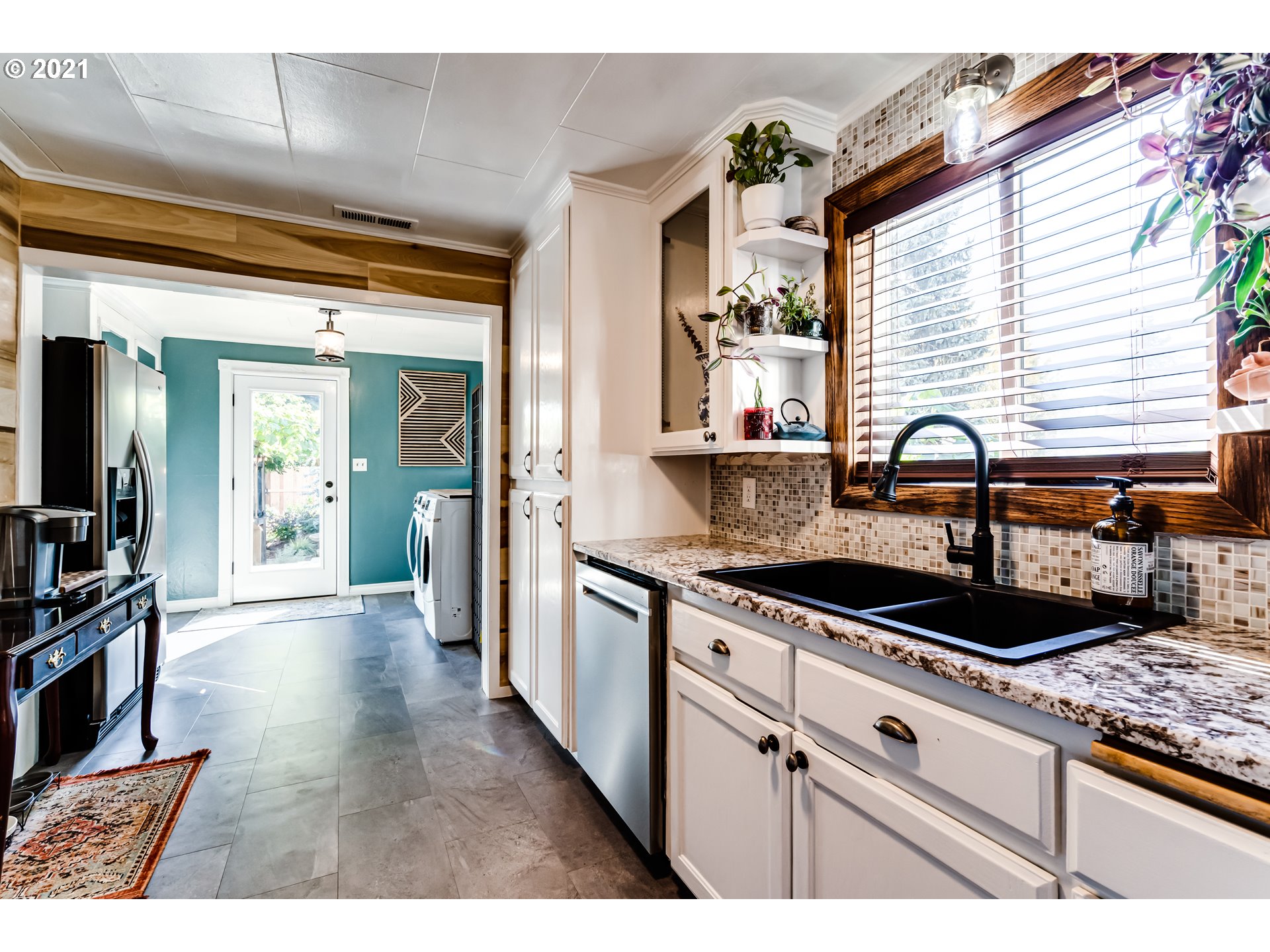 1327 E Street Springfield, OR 97477 - Photo 9 of 32 a kitchen with granite countertop a sink and cabinets