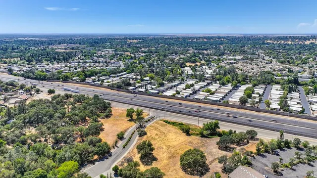 an aerial view of a residential houses with city view