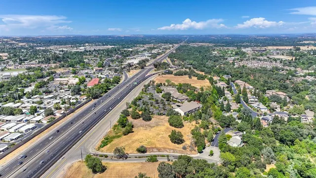 an aerial view of residential house with car parked
